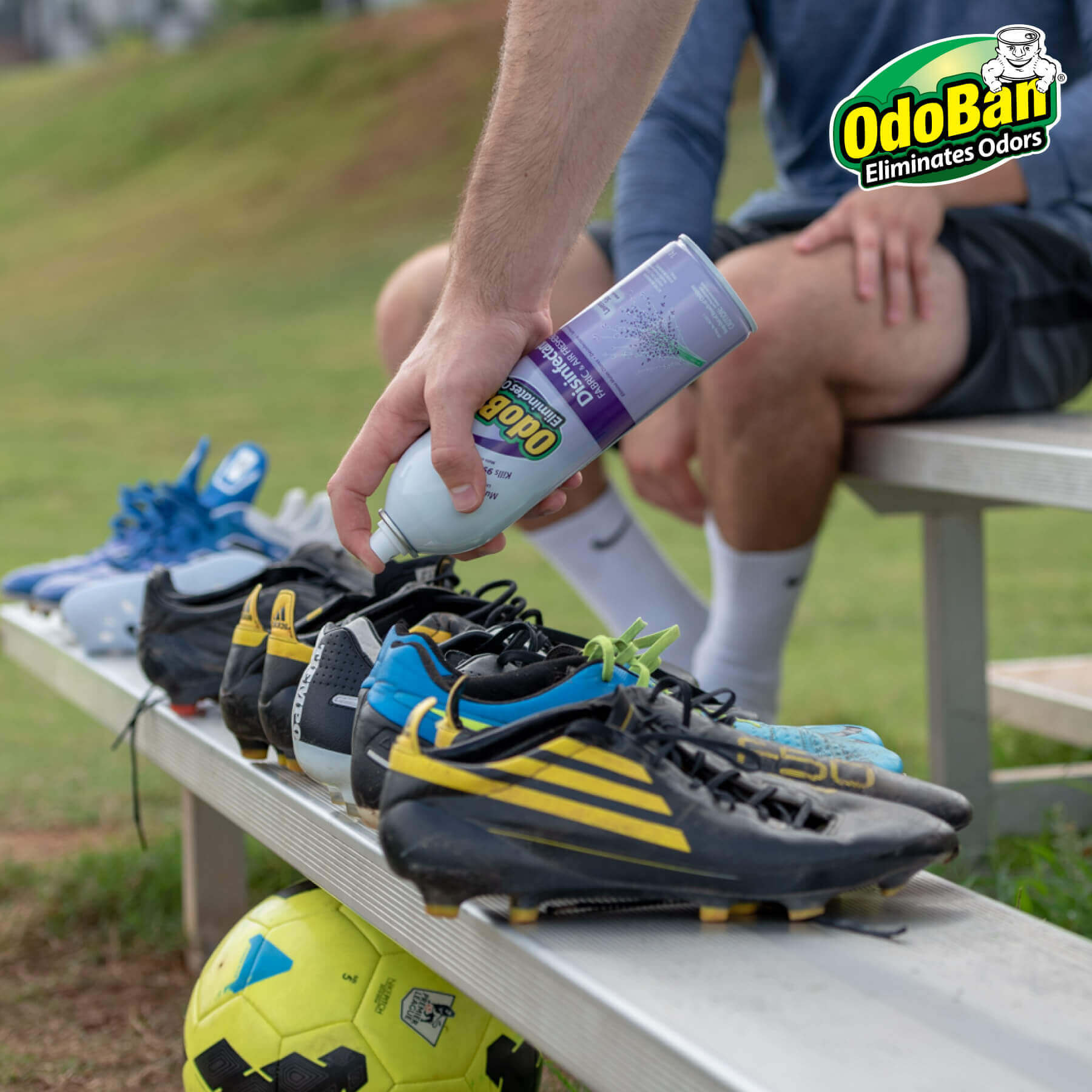 Man spraying OdoBan in smelly Soccer cleats.